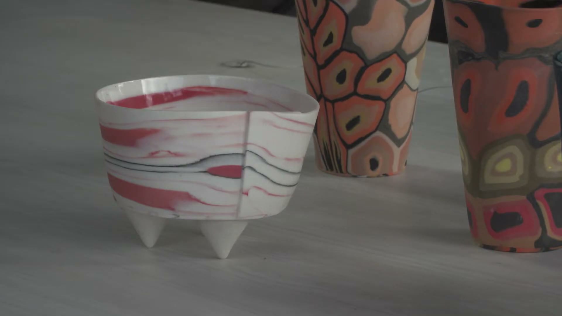 Nanna Bayer in her South Hobart studio, hands working coloured porcelain